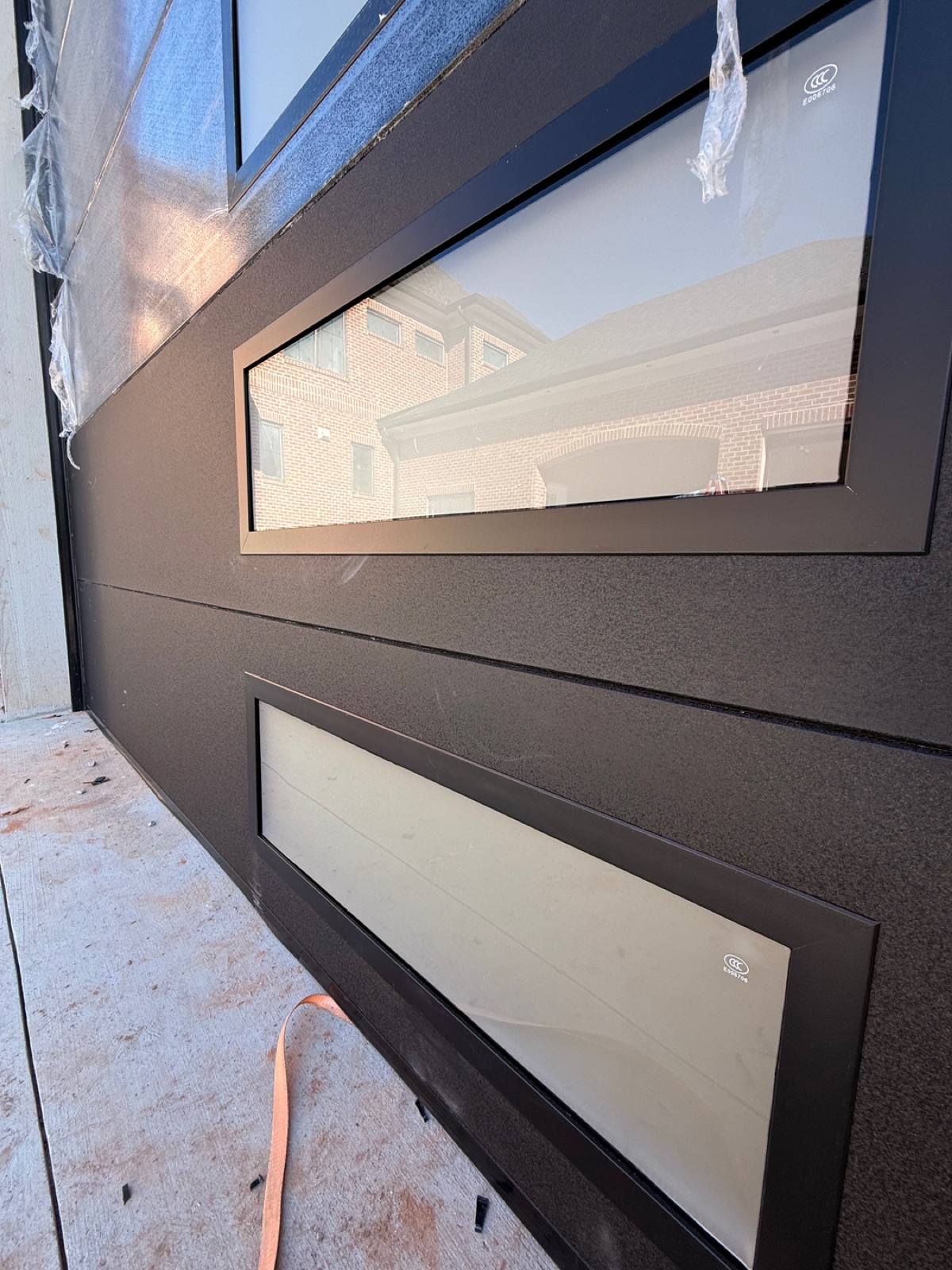 Modern black garage door with glass panels