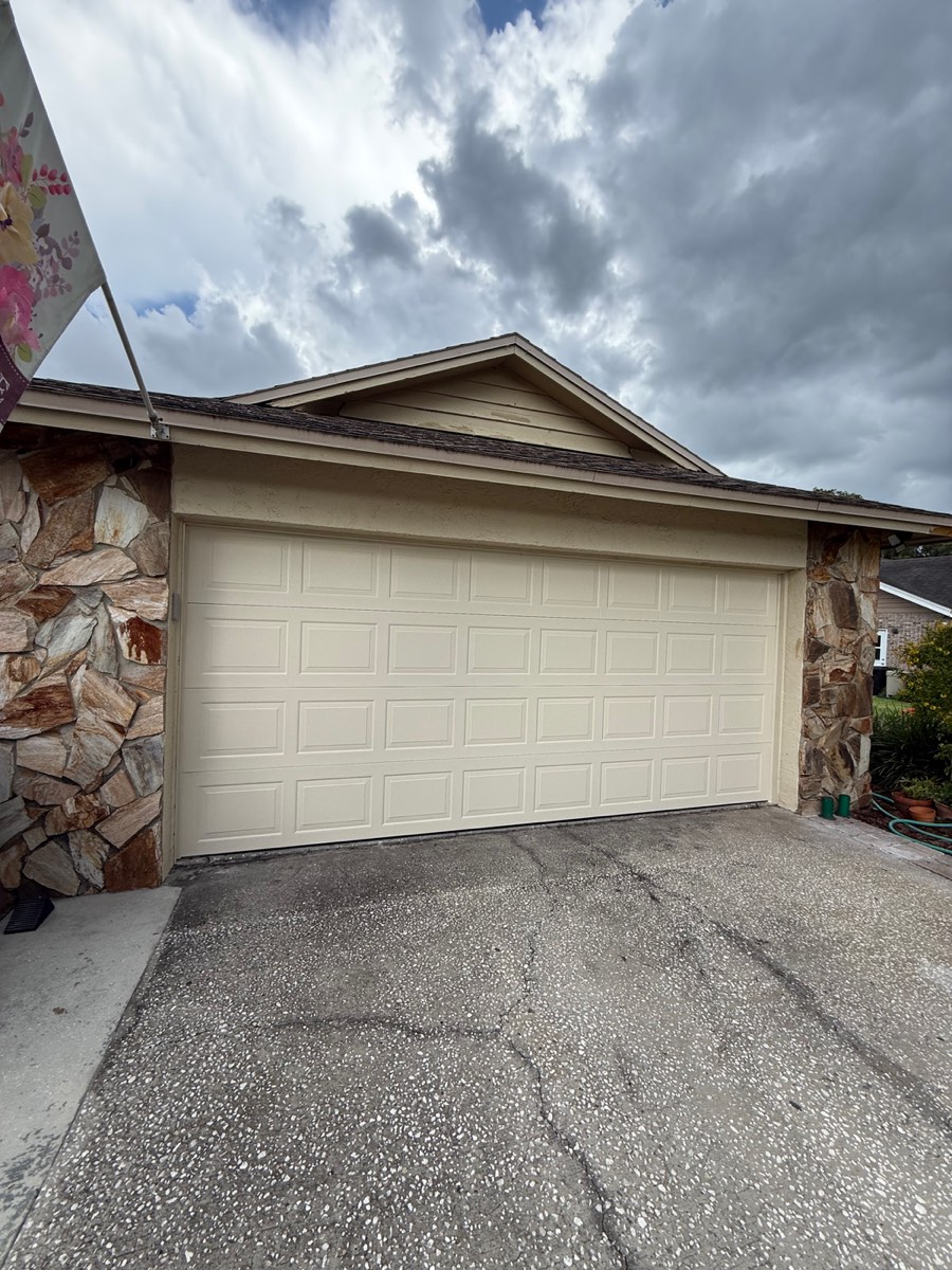 Almond steel raised-panel double garage door