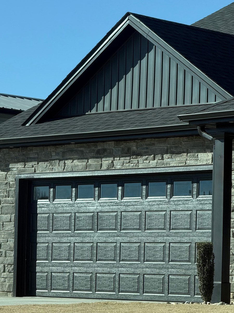 Grey steel raised-panel garage door on a stone home in Spartanburg SC