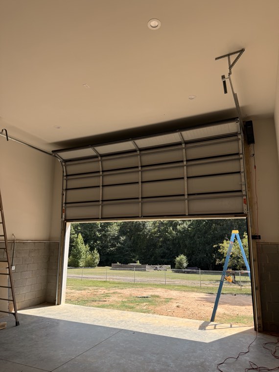 New commercial overhead door on its track inside a building under construction
