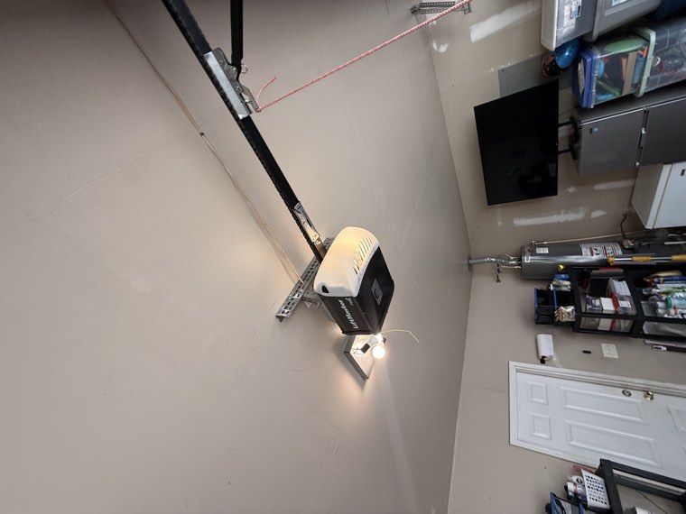 LiftMaster garage door opener mounted on the ceiling of a finished home garage