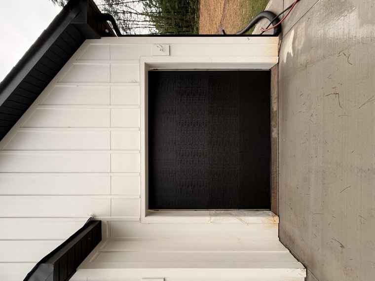 Single-car black flush garage door on a white board-and-batten farmhouse garage near Greer, SC