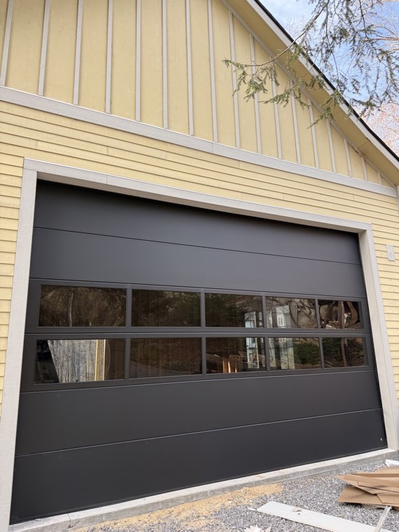 Black modern garage door with two rows of glass installed by Viking Garage Door in Spartanburg County, SC