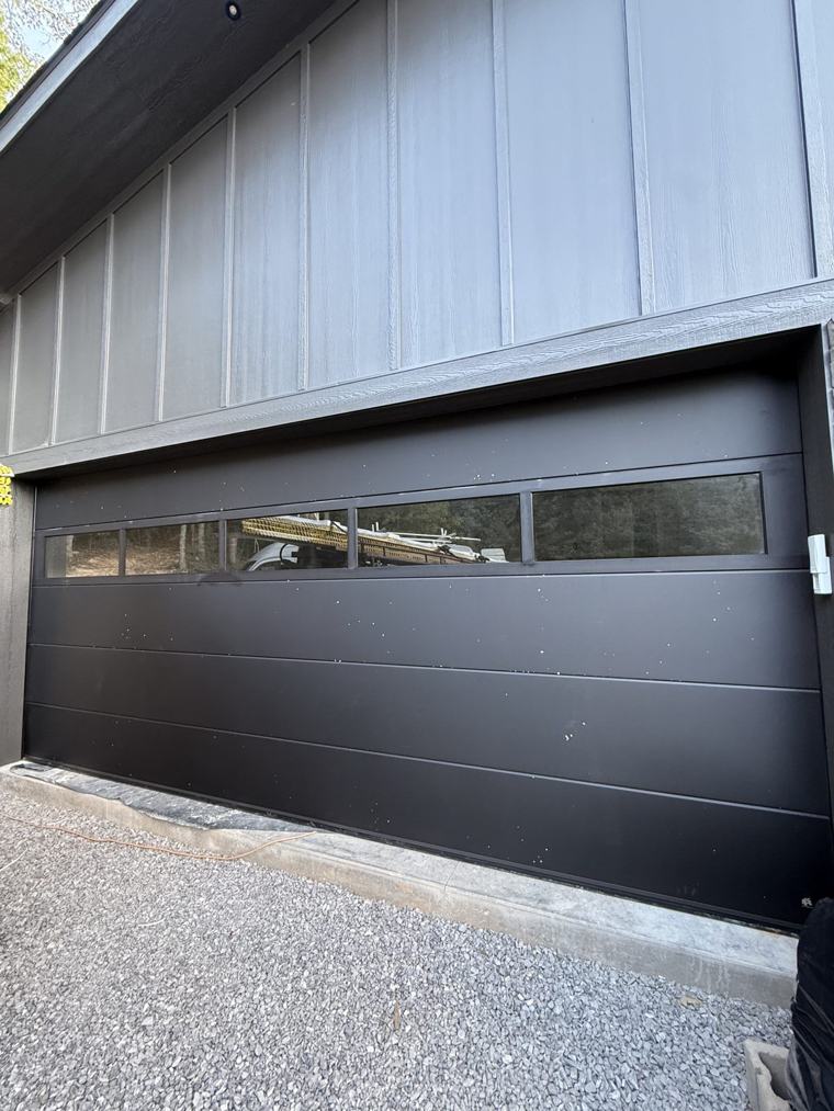 Matte black flush door with full-view glass top section — installed by Viking Garage Door, Upstate SC