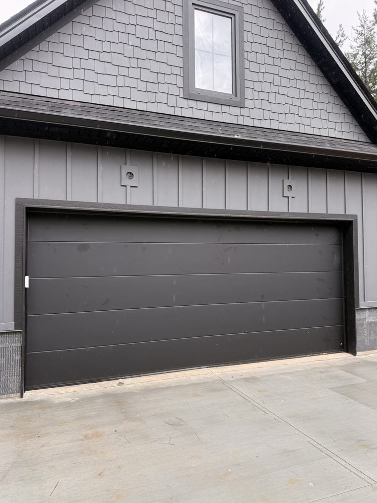 Matte black flush garage door, no windows — installed by Viking Garage Door, Upstate SC