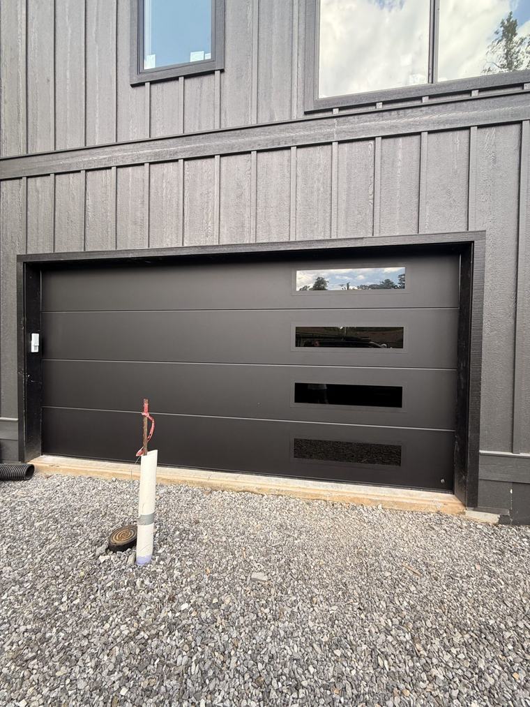 Matte black flush door with stacked side windows — installed by Viking Garage Door, Upstate SC
