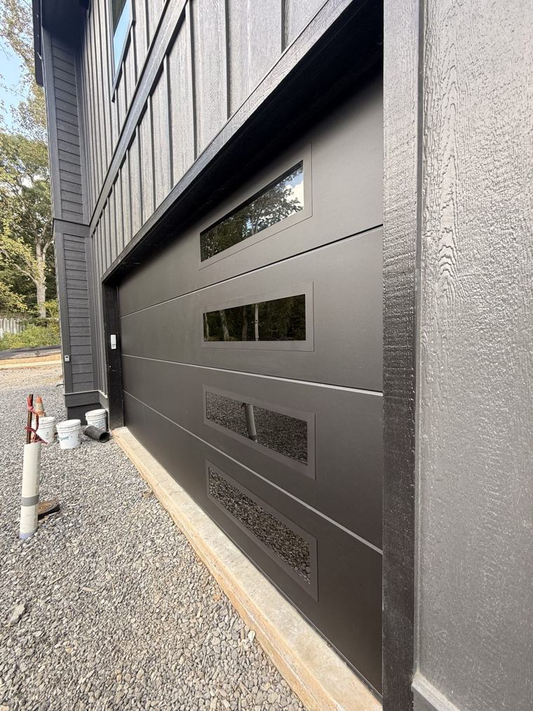 Matte black flush door with stacked side windows, angle view — installed by Viking Garage Door, Upstate SC