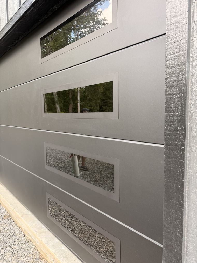 Close-up of stacked windows on a matte black flush door — installed by Viking Garage Door, Upstate SC