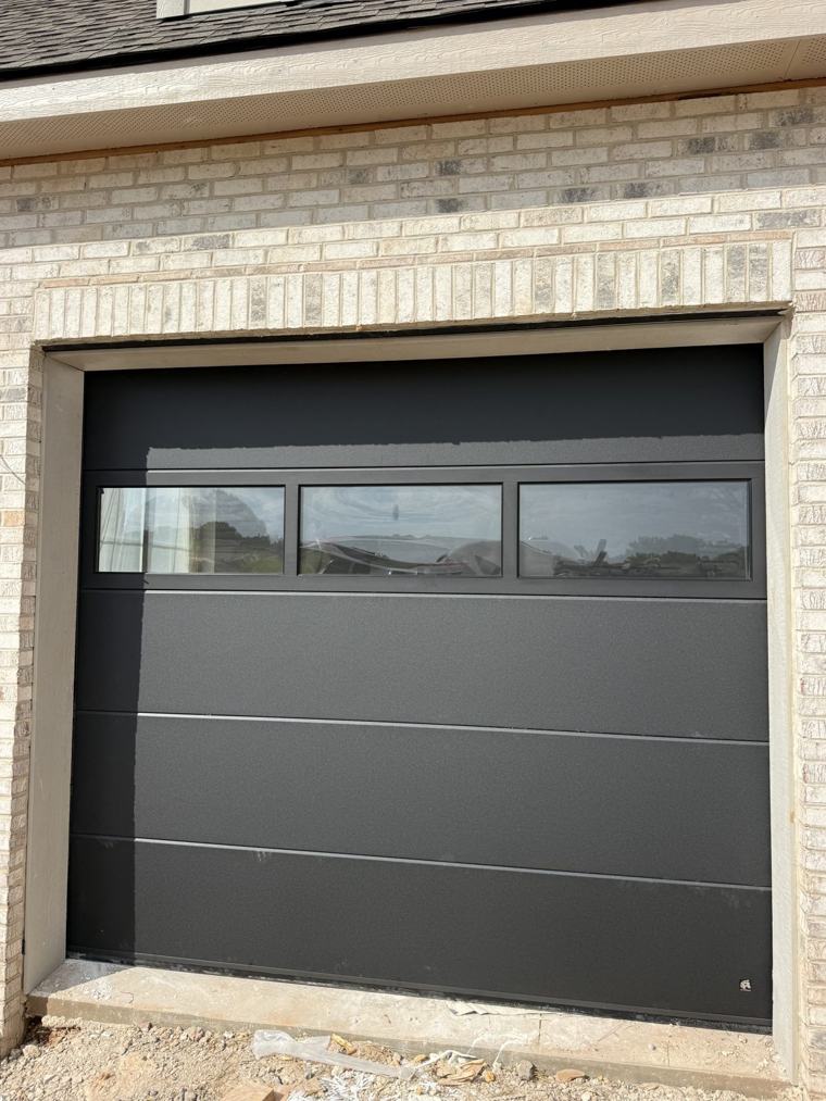 Single matte black door with full-view glass top section — installed by Viking Garage Door, Upstate SC