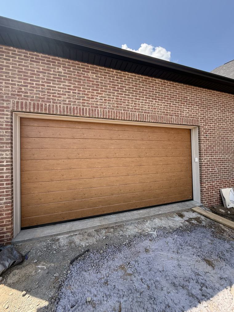 Woodgrain flush steel garage door, angle view — installed by Viking Garage Door, Upstate SC